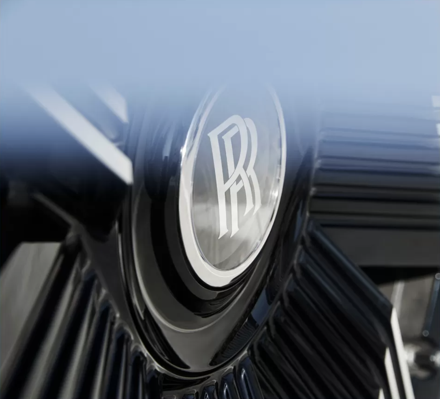 A close up with blue blur of a Rolls Royce wheel hub