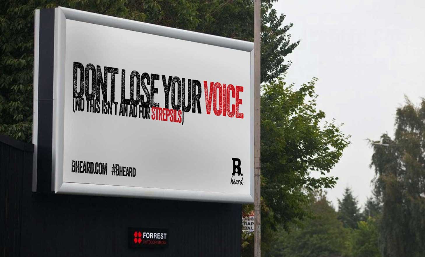 White billboard has black and red text saying 'Dont lose your voice (no this isn't an ad for strepsils)